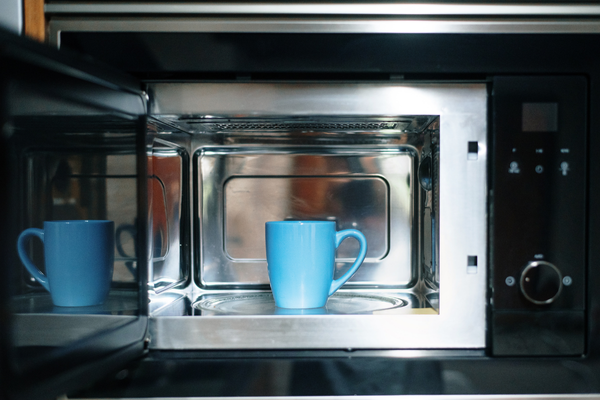 light blue cup in a gray microwave